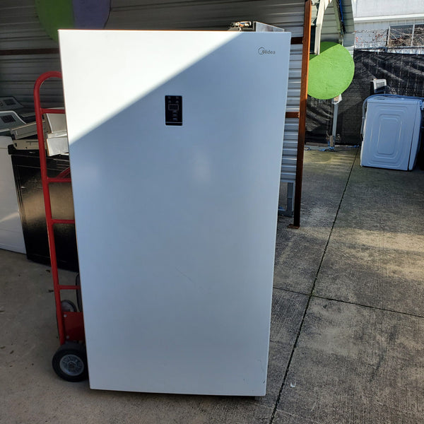 A salvage Midea stand up freezer that recently sold in a truckload of salvage appliances.