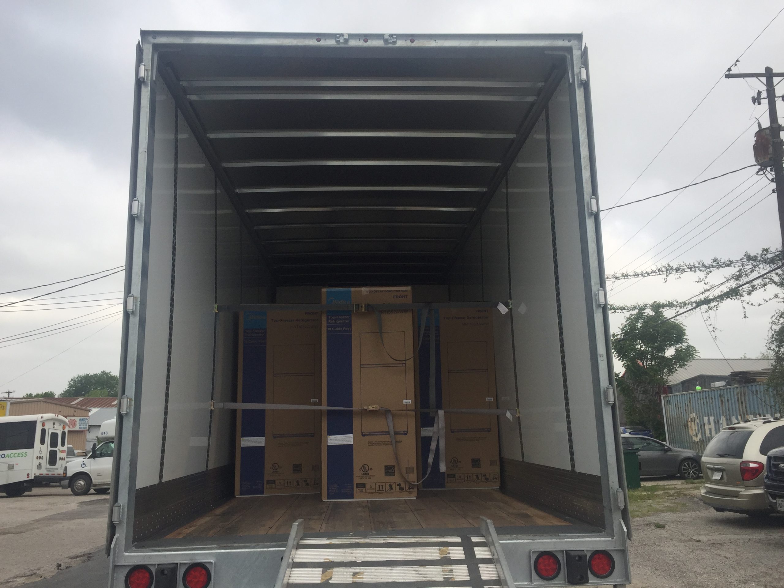 example pictures of Another truckload of new Demanufacture Midea 18 cu ft refrigerators.